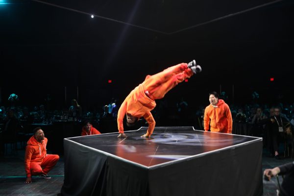 Break dancers in orange jumpsuits